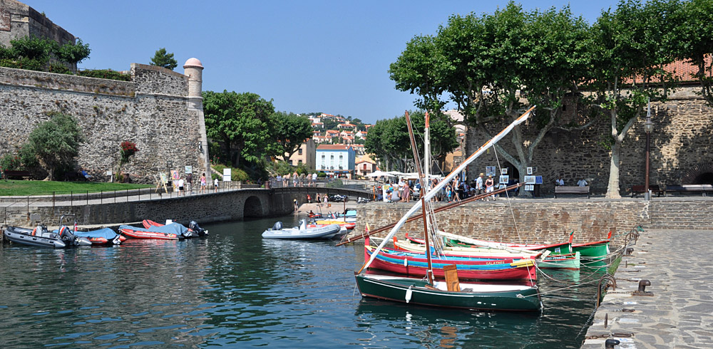 Collioure harbour with colourful lateen boats tied up beside the quay