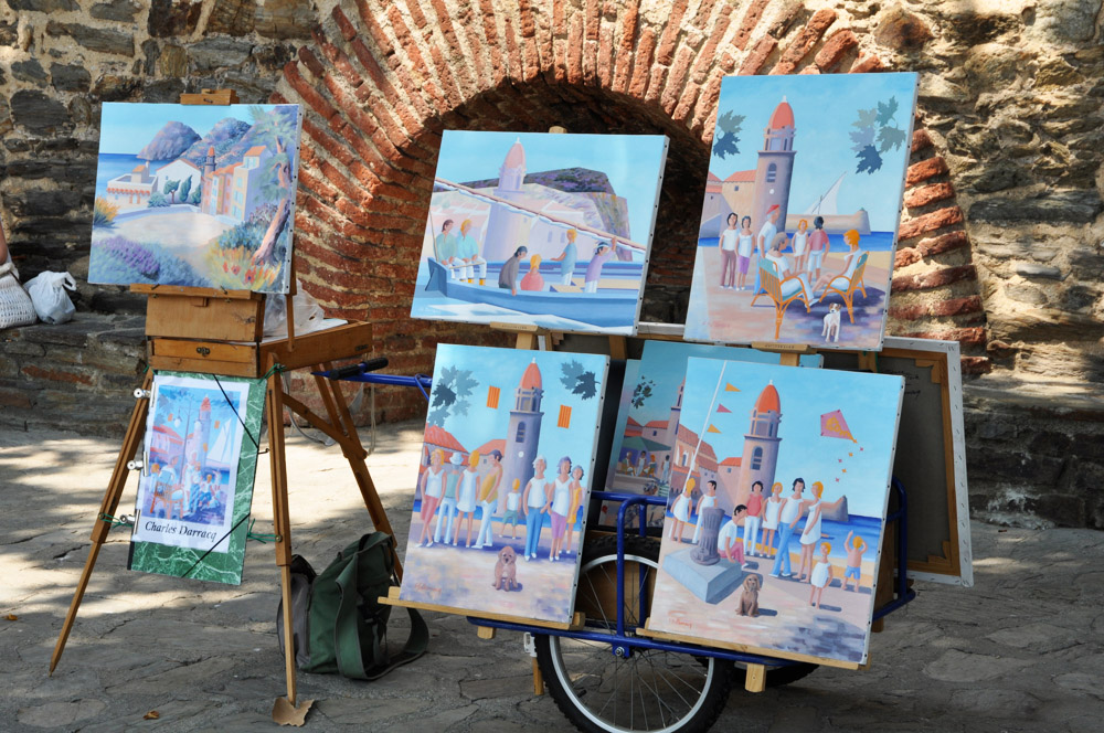 Artists paintings on the harbour wall in Collioure